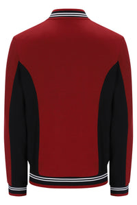 A red and black colorblock knit jacket shown from the back, featuring white and black striped ribbing on the collar, cuffs, and hem.