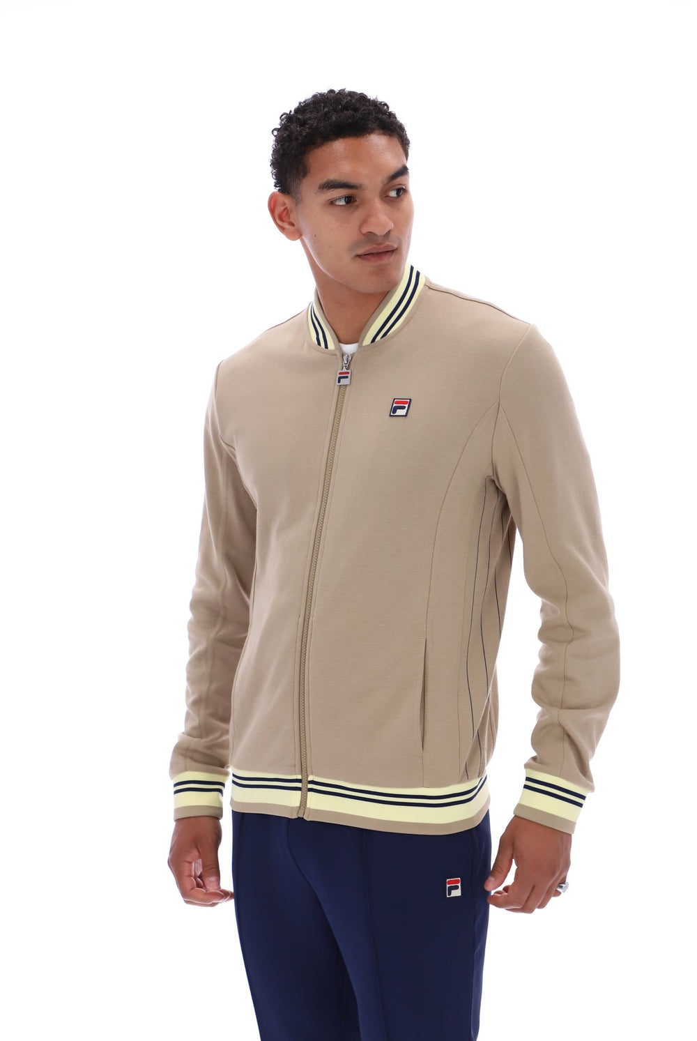 Displays a model wearing the Chinchilla Double Cream 'Fila' branded Navy Settanta Baseball Track Top