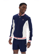 Man wearing a navy tracksuit Jacket with white accents on a white background
