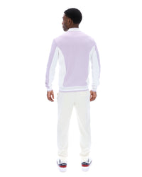 Displays a model wearing the Misty Lilac 'FILA' branded Settanta Baseball Track Top