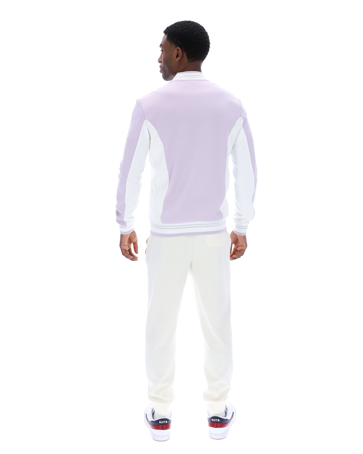 Displays a model wearing the Misty Lilac 'FILA' branded Settanta Baseball Track Top