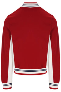 A red long-sleeve varsity-style jacket shown from the back, featuring white side panels and striped ribbed trim at the collar, hem, and cuffs.