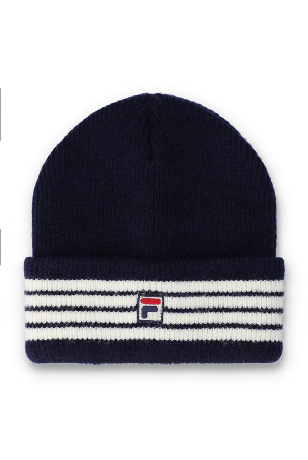 A navy blue knit beanie hat featuring a folded cuff with horizontal white and navy stripes and a small embroidered Fila logo in the center.