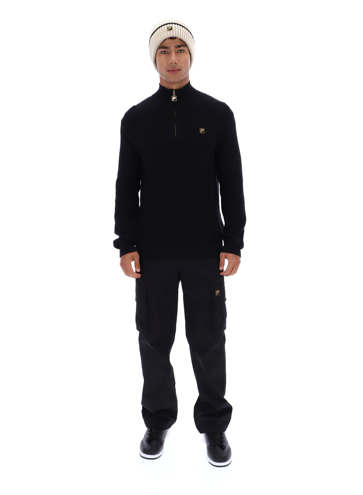 Displays a model wearing the Black 'FILA' branded Stevie 1/4 Zip Funnel Neck Textured Knit