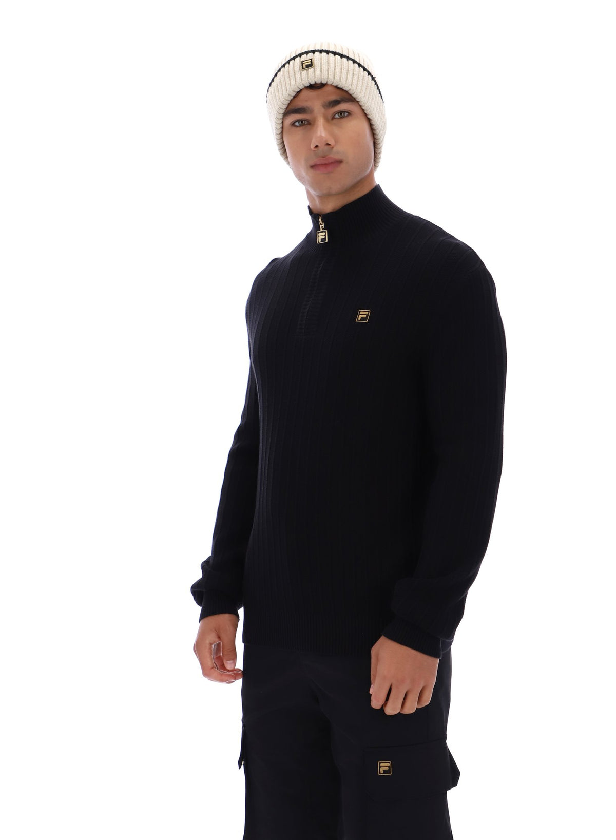 Displays a model wearing the Black 'FILA' branded Stevie 1/4 Zip Funnel Neck Textured Knit