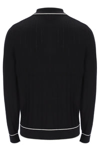 Black sweater with white trim on a white background