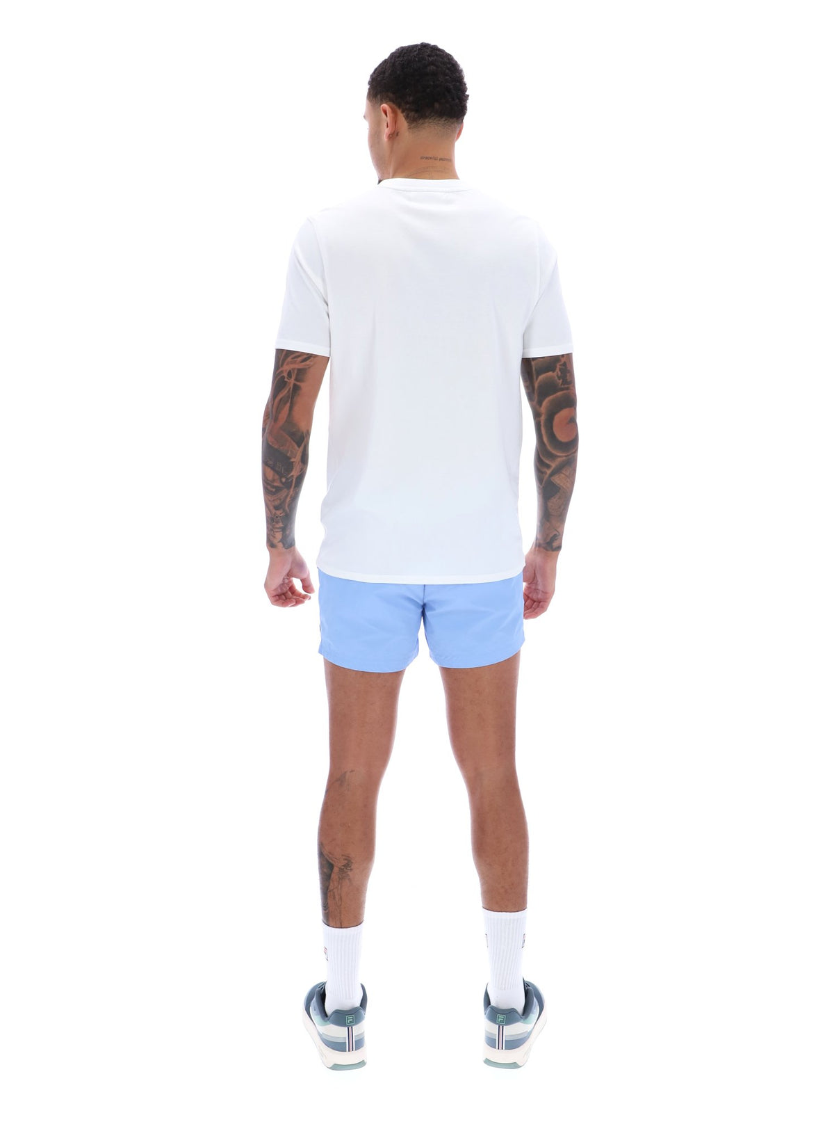 Person wearing a white t-shirt and light blue shorts on a white background