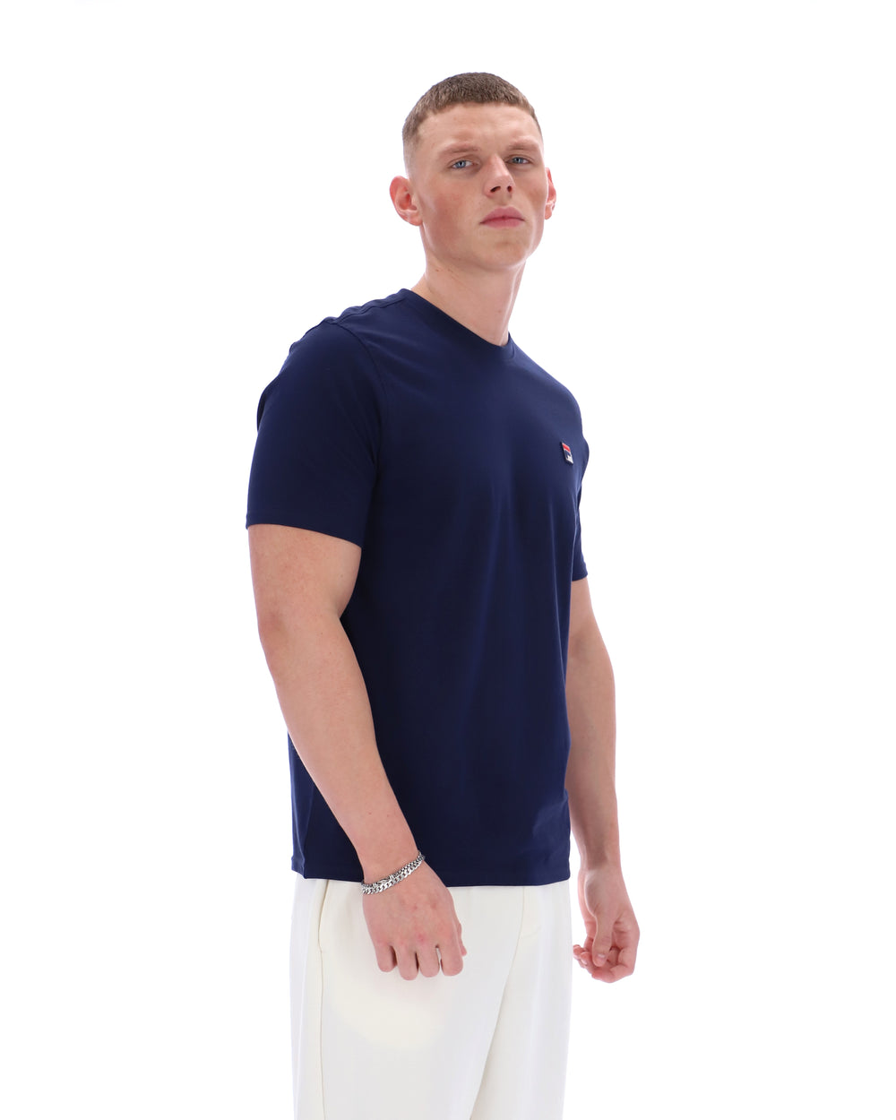 Man wearing a navy blue t-shirt with a logo on a white background