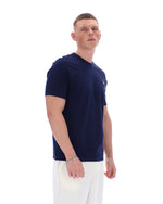 Man wearing a navy blue t-shirt with a logo on a white background