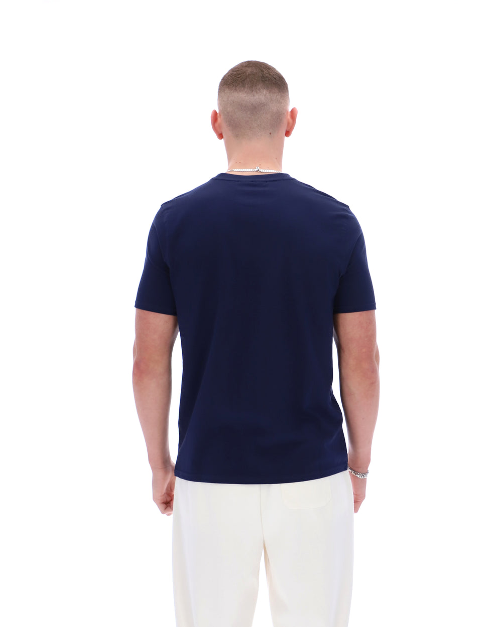 Man wearing a navy blue t-shirt on a white background
