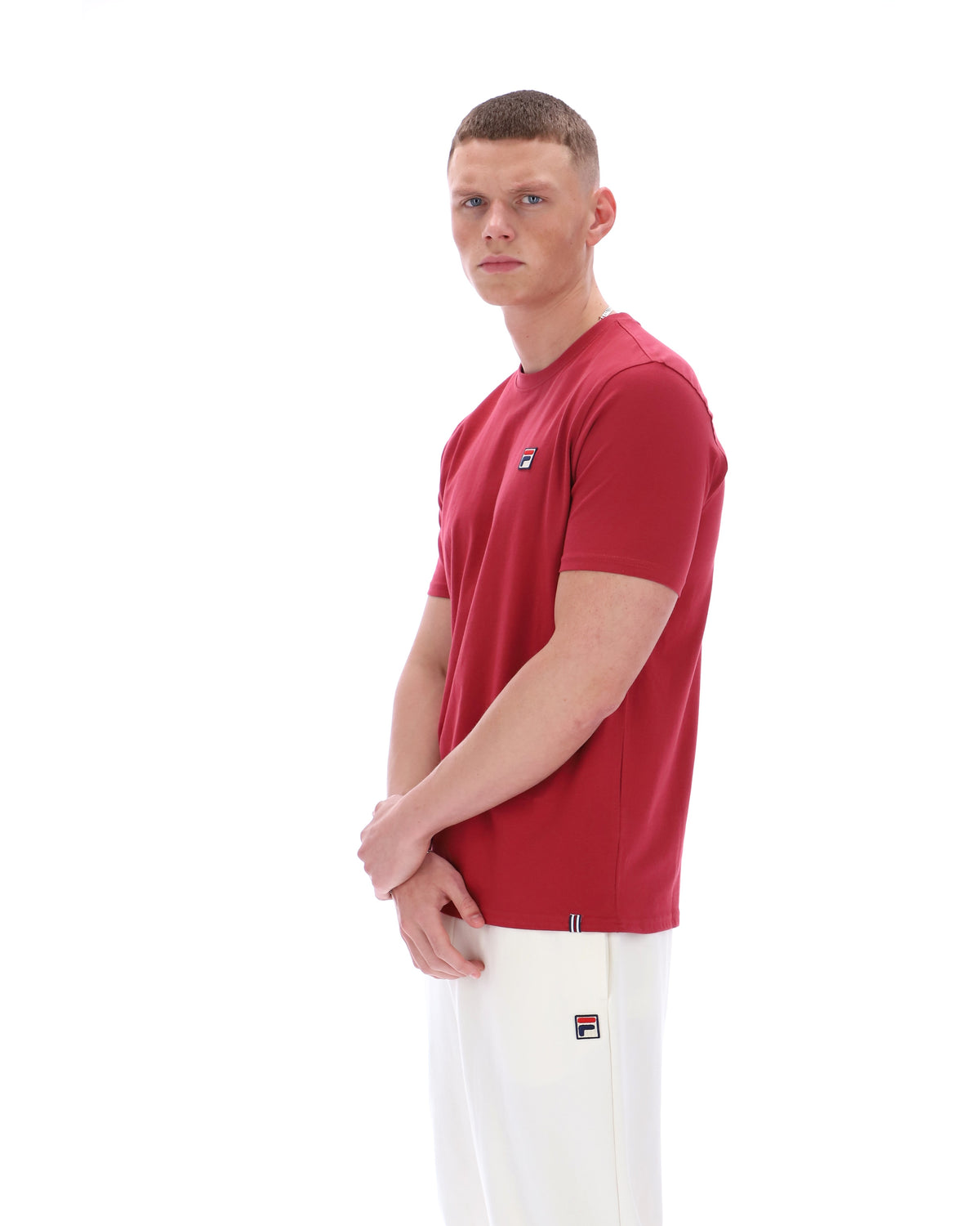 Man wearing a red t-shirt with a logo on a white background