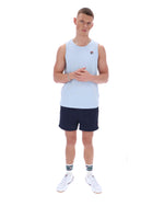 Man wearing a light blue sleeveless shirt and navy shorts on a white background