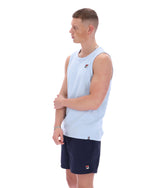 Man wearing a light blue sleeveless shirt and navy shorts with a brand logo on a white background