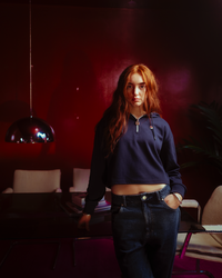 Displays a model wearing the Navy 'FILA' branded Fiorella 1/4 Zip Up Hoodie