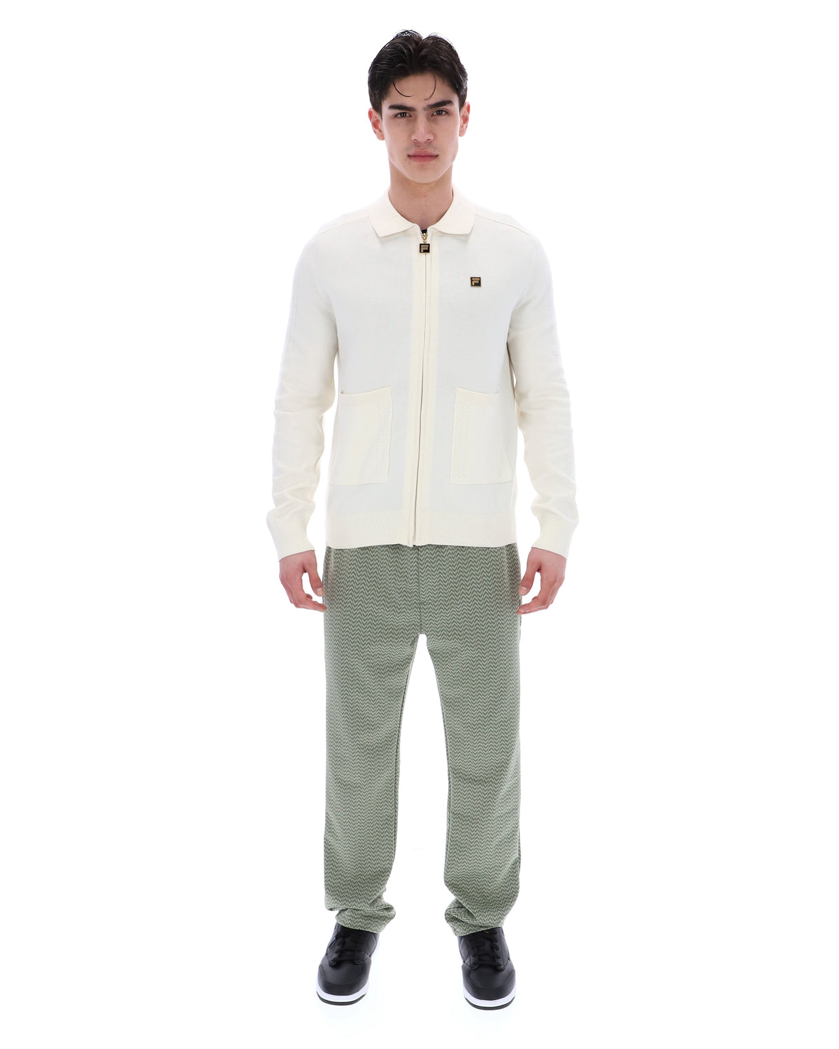 Displays a model wearing the Coconut Milk 'FILA' branded Teddy Knitted Shirt