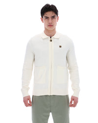 Displays a model wearing the Coconut Milk 'FILA' branded Teddy Knitted Shirt