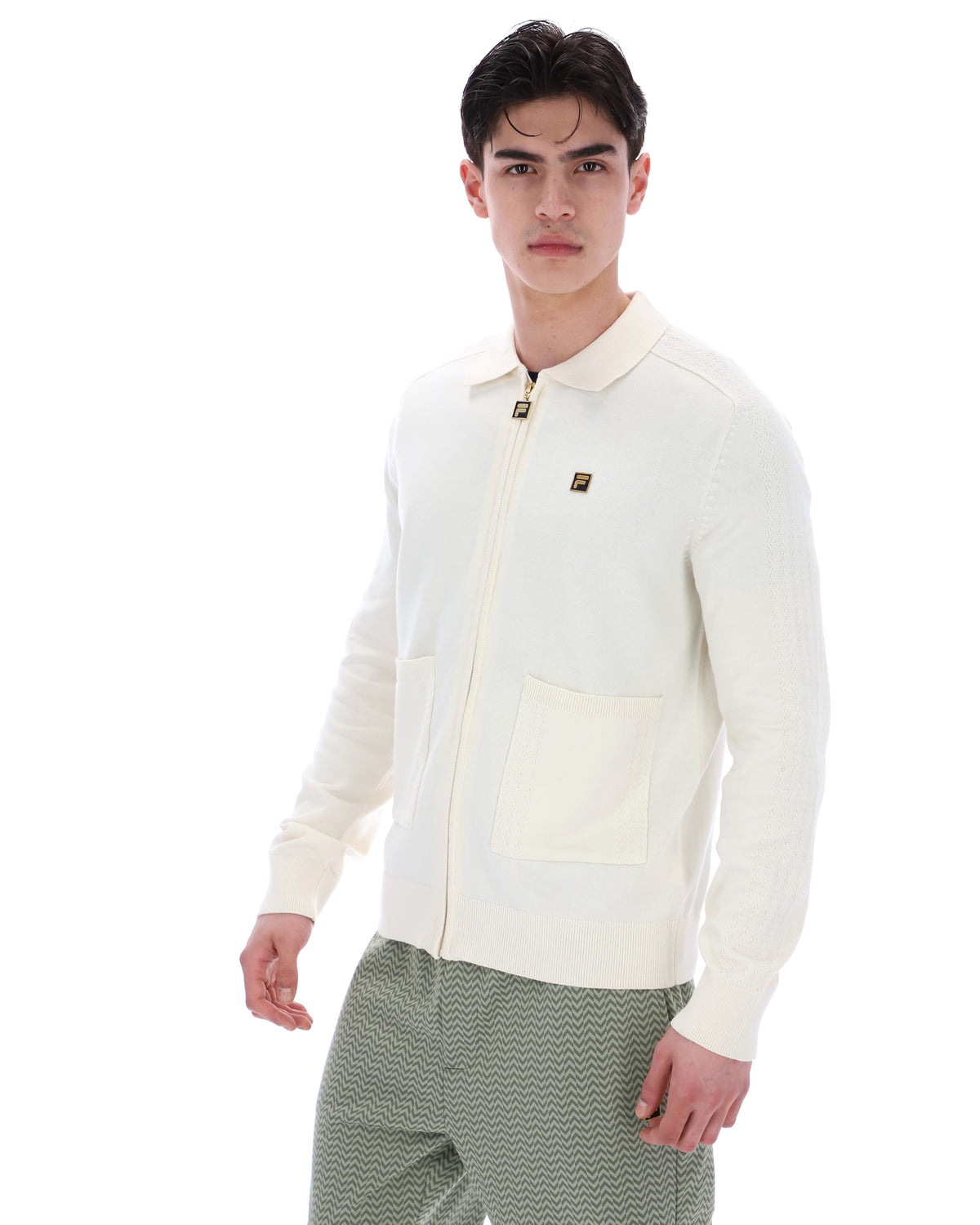 Displays a model wearing the Coconut Milk 'FILA' branded Teddy Knitted Shirt