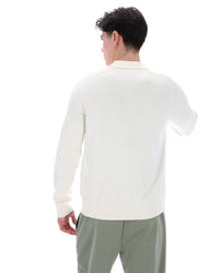 Displays a model wearing the Coconut Milk 'FILA' branded Teddy Knitted Shirt