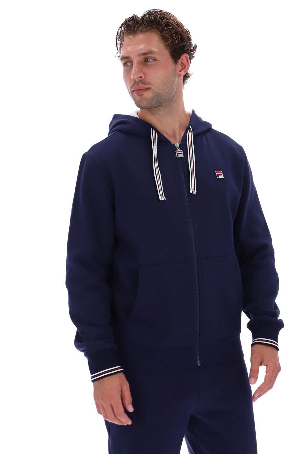 Displays a model wearing the 'Fila' branded Navy/ Gardenia Tenconi 2 Zip Thru Hoodie