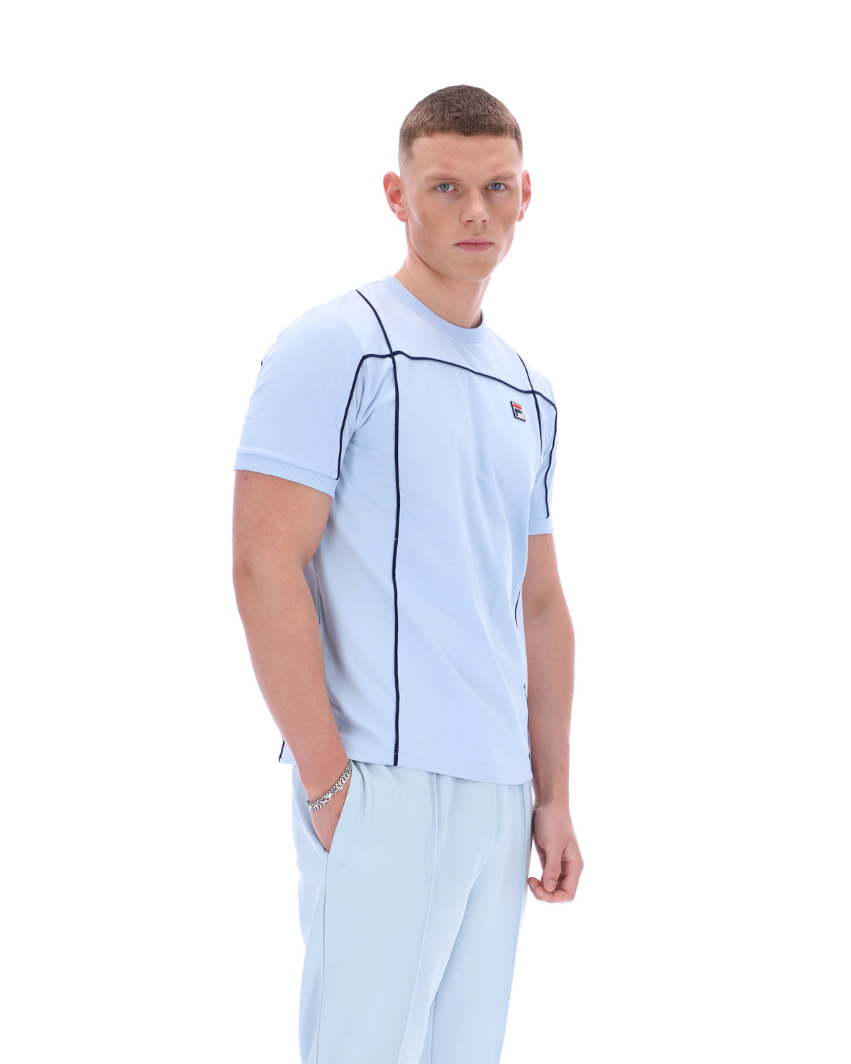 Displays a model wearing the Skyway 'FILA' branded Terri T-Shirt with Contrast Piping