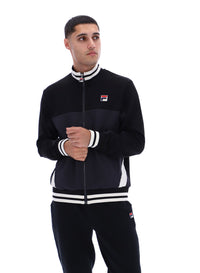 Person wearing a black tracksuit with white accents and FILA logo on a white background