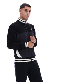 Man wearing a black tracksuit with white accents on a white background