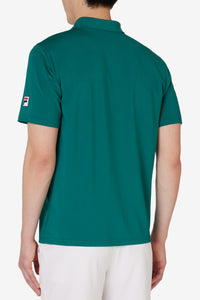 Displays a model wearing the Green 'FILA' branded Tennis Essentials Top
