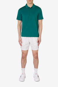 Displays a model wearing the Green 'FILA' branded Tennis Essentials Top