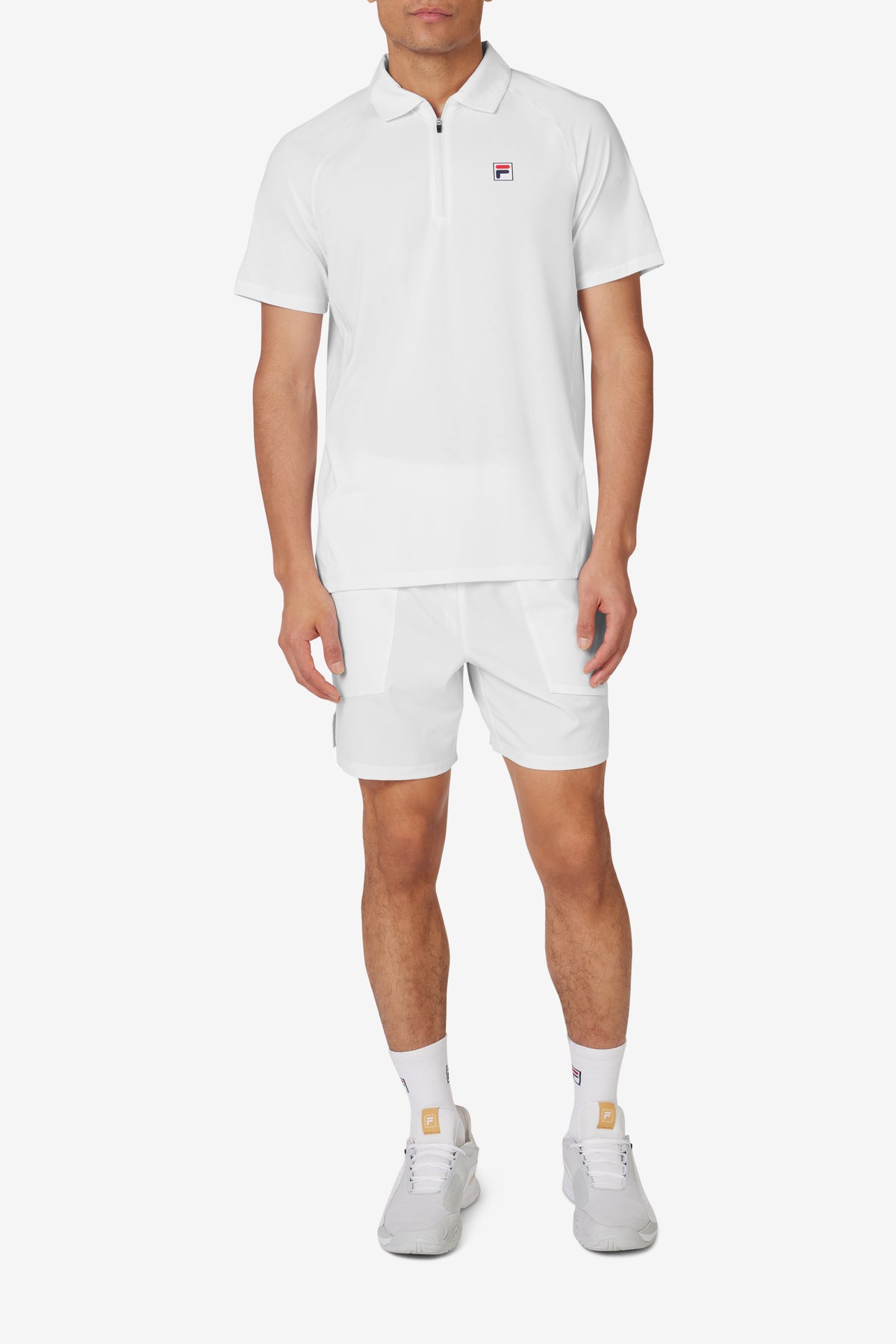 White short sleeve tennis polo with a collar, a zip-up shirt, and a FILA logo on the chest.