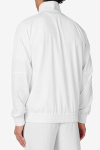 A man wearing a white FILA tennis court track jacket with matching white pants.
