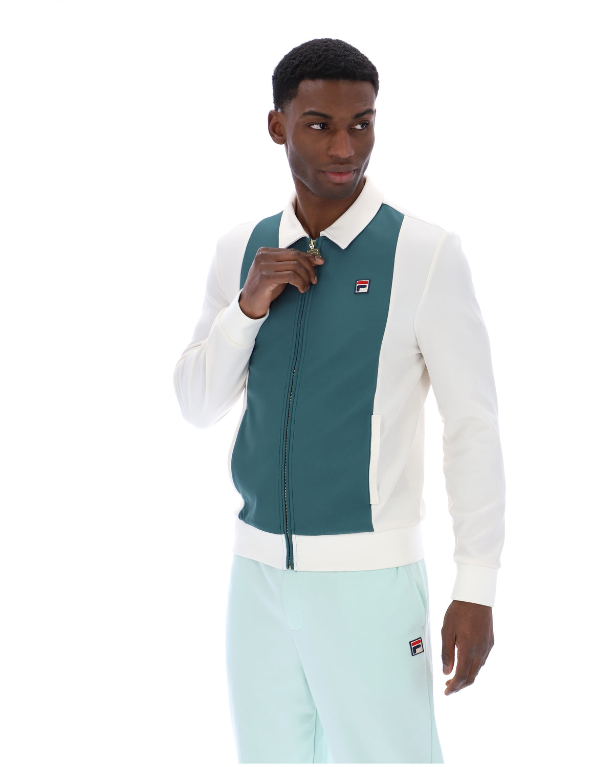 Man wearing a green and white jacket with a visible brand logo on a white background
