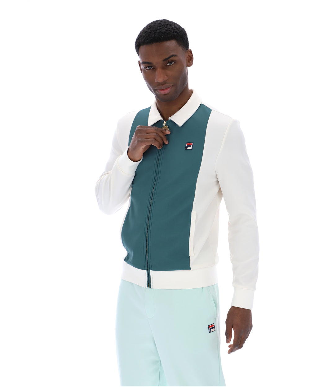 Man wearing a green and white jacket with a visible brand logo on a white background