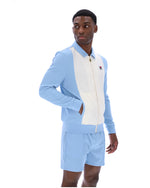 Man wearing a light blue tracksuit with a white panel on a white background
