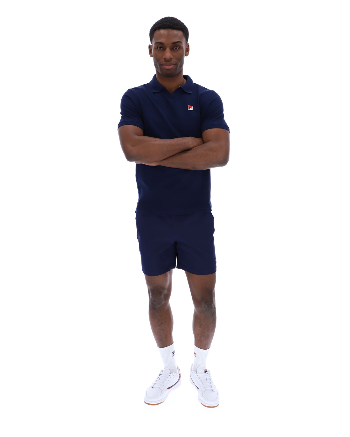 Displays a model wearing the Navy 'Fila' branded Tristiano Textured Polo