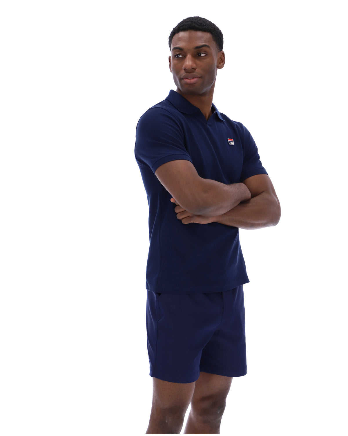 Displays a model wearing the Navy 'Fila' branded Tristiano Textured Polo