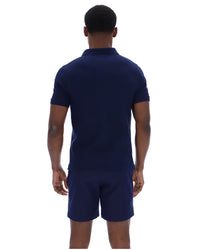 Displays a model wearing the Navy 'Fila' branded Tristiano Textured Polo