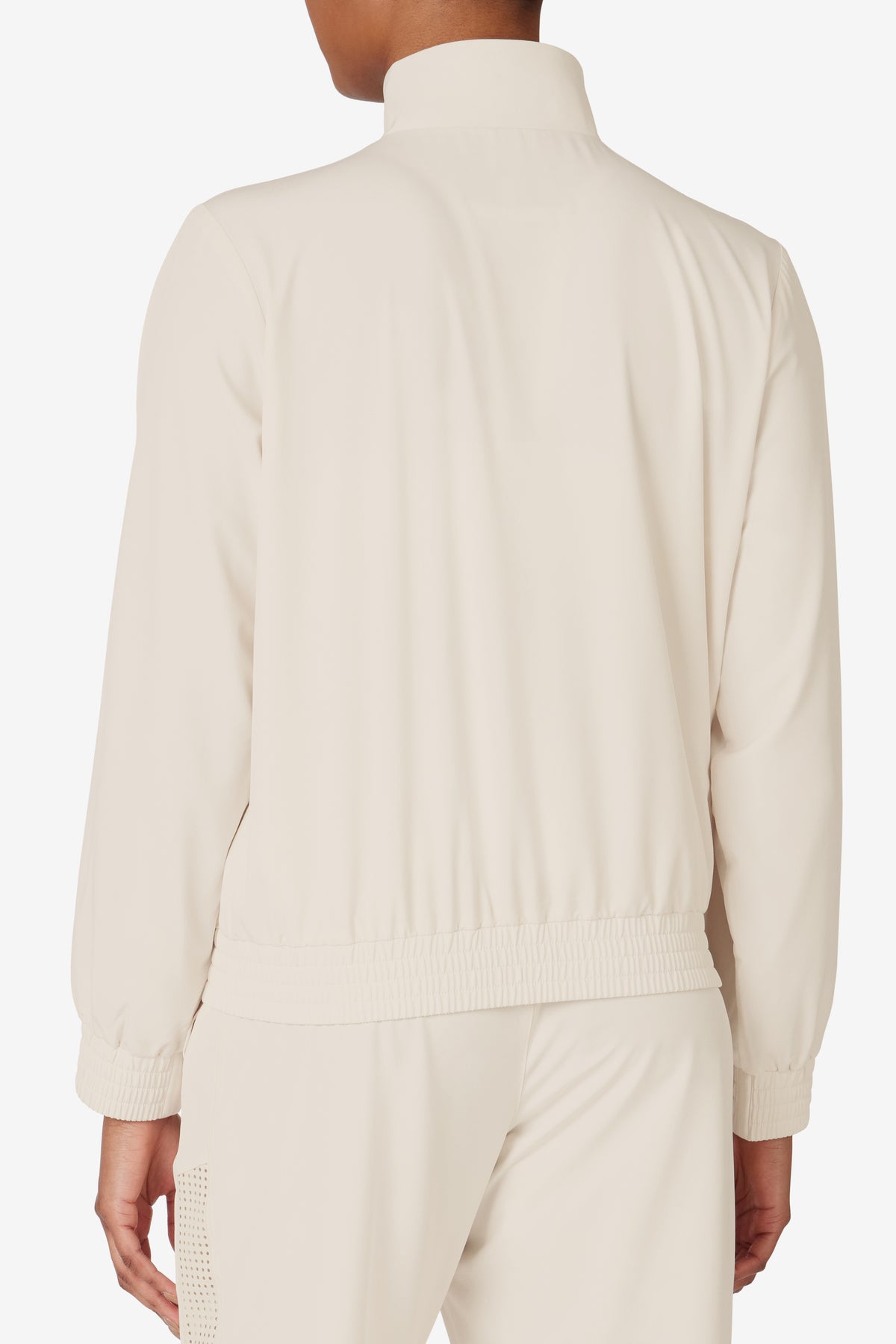 Displays a model wearing the Beige 'FILA' branded Tennis Advantage Track Top