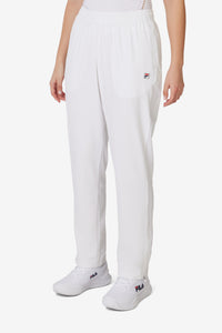 Displays a model wearing the White 'FILA' branded Tennis Advantage Track Pant