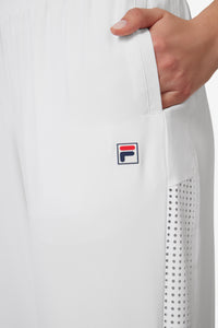 Displays a model wearing the White 'FILA' branded Tennis Advantage Track Pant featuring the FILA branded logo