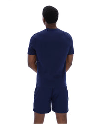 Person wearing a navy blue outfit on a white background