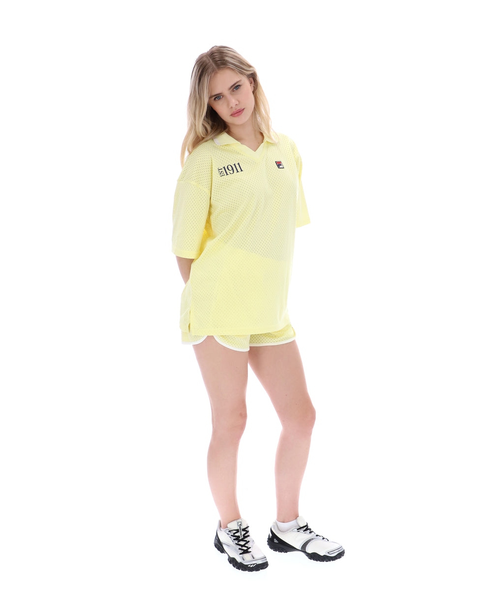 Woman wearing a yellow outfit with a logo on a white background