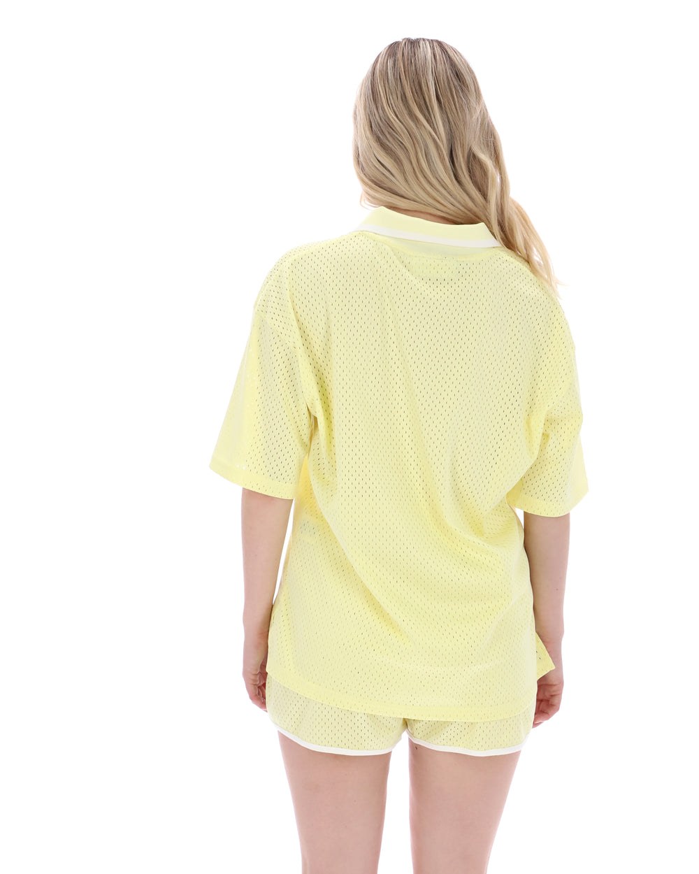 Person wearing a yellow outfit with a white background