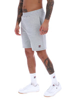 Model wearing Grey tracksuit shorts with FILA logo branding
