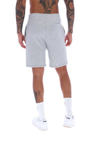 A male model wearing grey Vico Fleece short by FILA, with a relaxed fit and side pockets, in a light grey marl colour.
