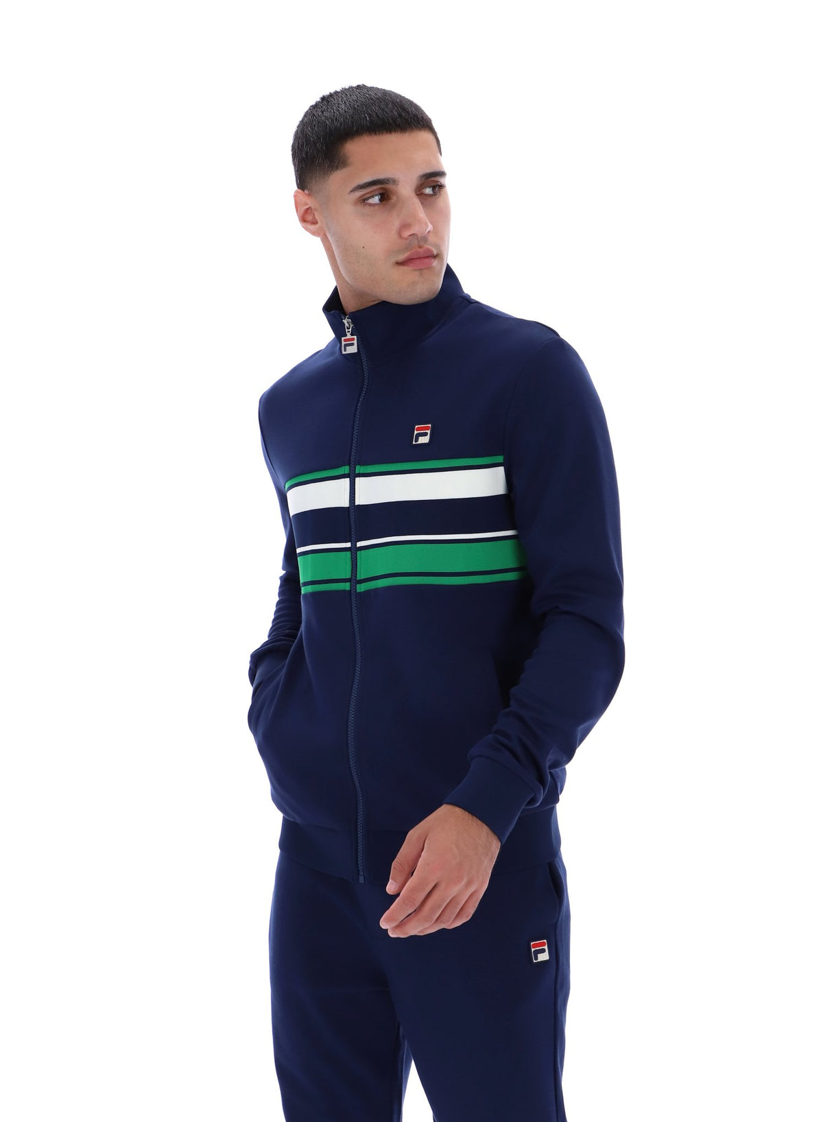 Displays a model wearing the Navy 'FILA' Vinnie Track Top