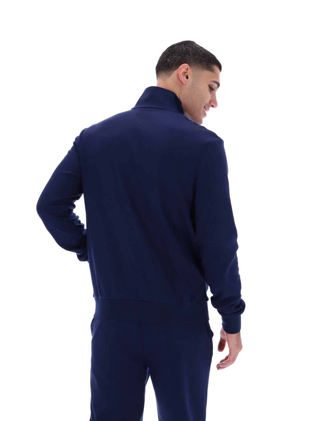 Displays a model wearing the Navy 'FILA' Vinnie Track Top