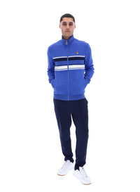 Displays the model wearing the Dazzling Blue 'FILA' branded Vinnie Track Top