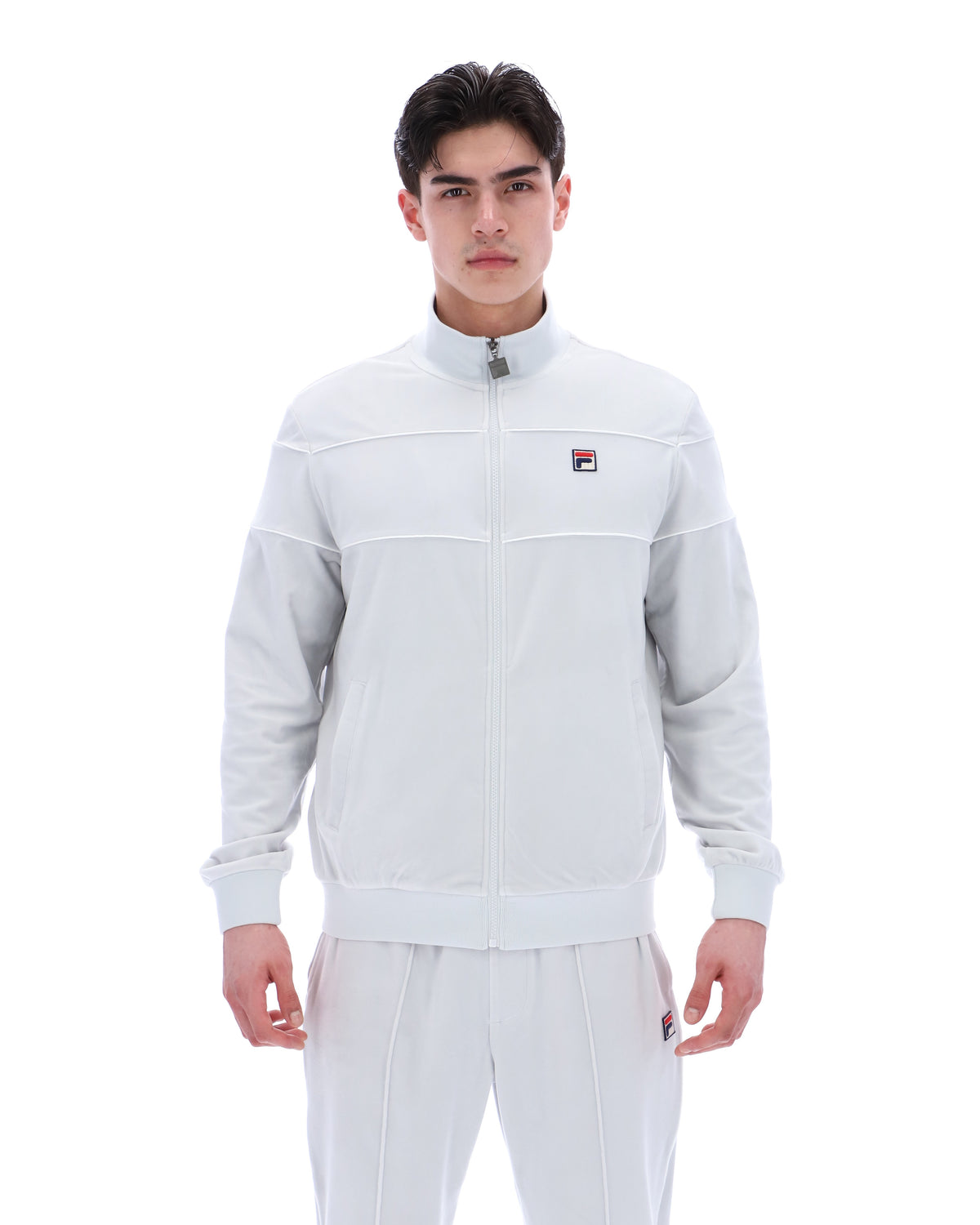 Displays a model wearing the Dawn Blue 'FILA' branded Vittorio Velour Track Top