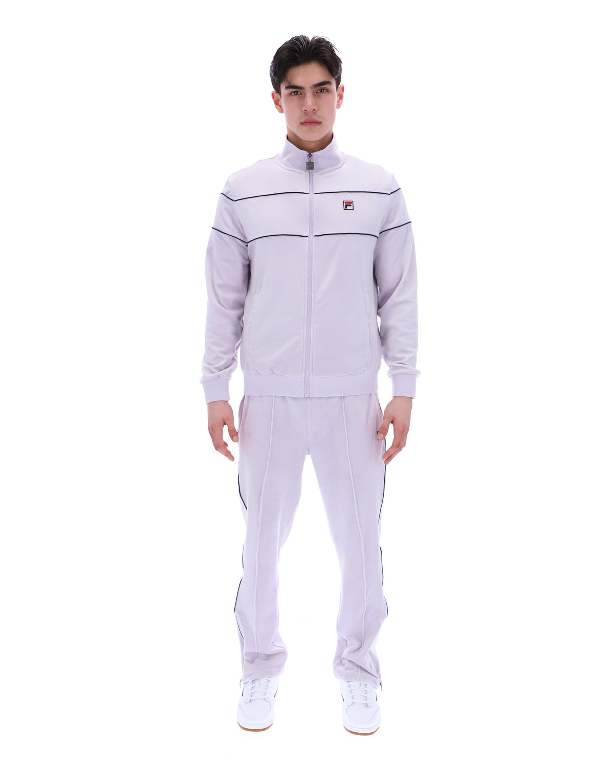 Displays a model wearing the Misty Lilac 'FILA' branded Vittorio Velour Track Top