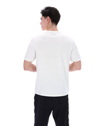 Person wearing a white polo shirt and black pants on a white background